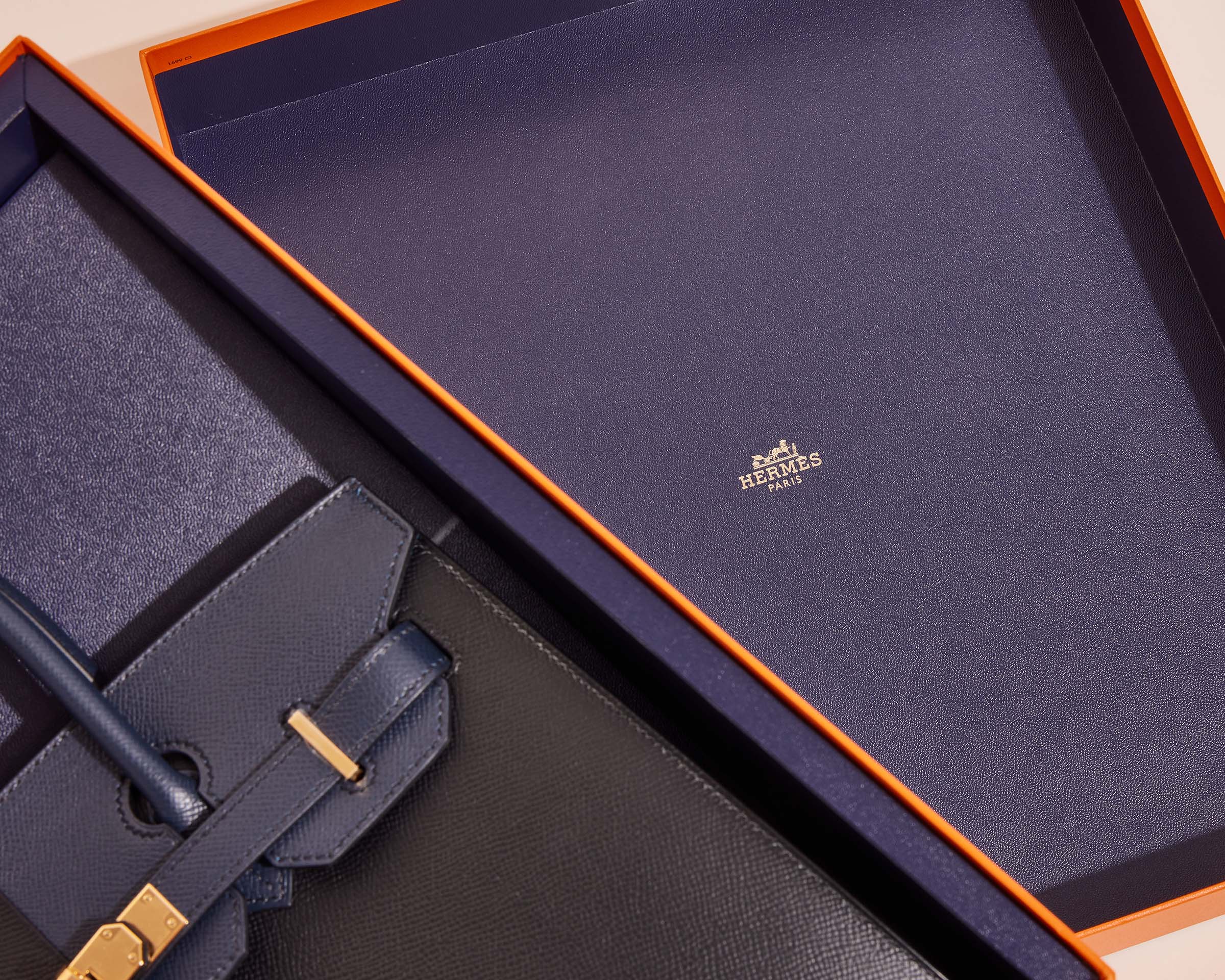 Hermès Blue Box next to classic orange box, showing navy interior