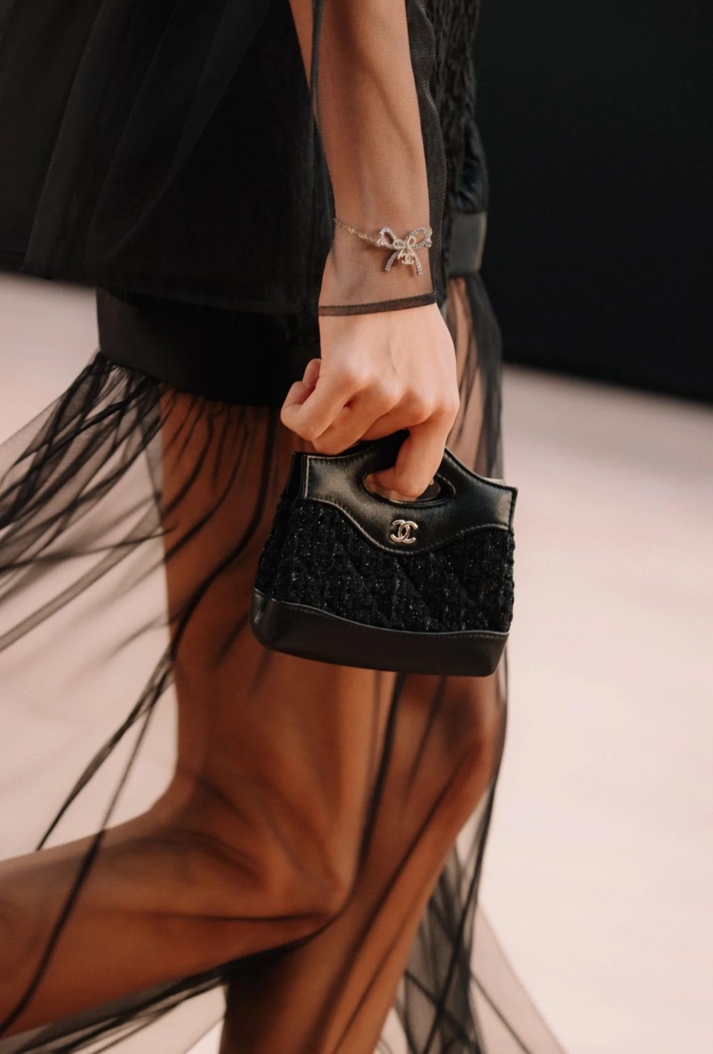 Model carrying Chanel micro 31 bag in black metallic tweed – Fall Winter 2025/26